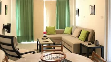 Apartment, 1 Bedroom | Living room | 55-inch flat-screen TV with digital channels, LED TV