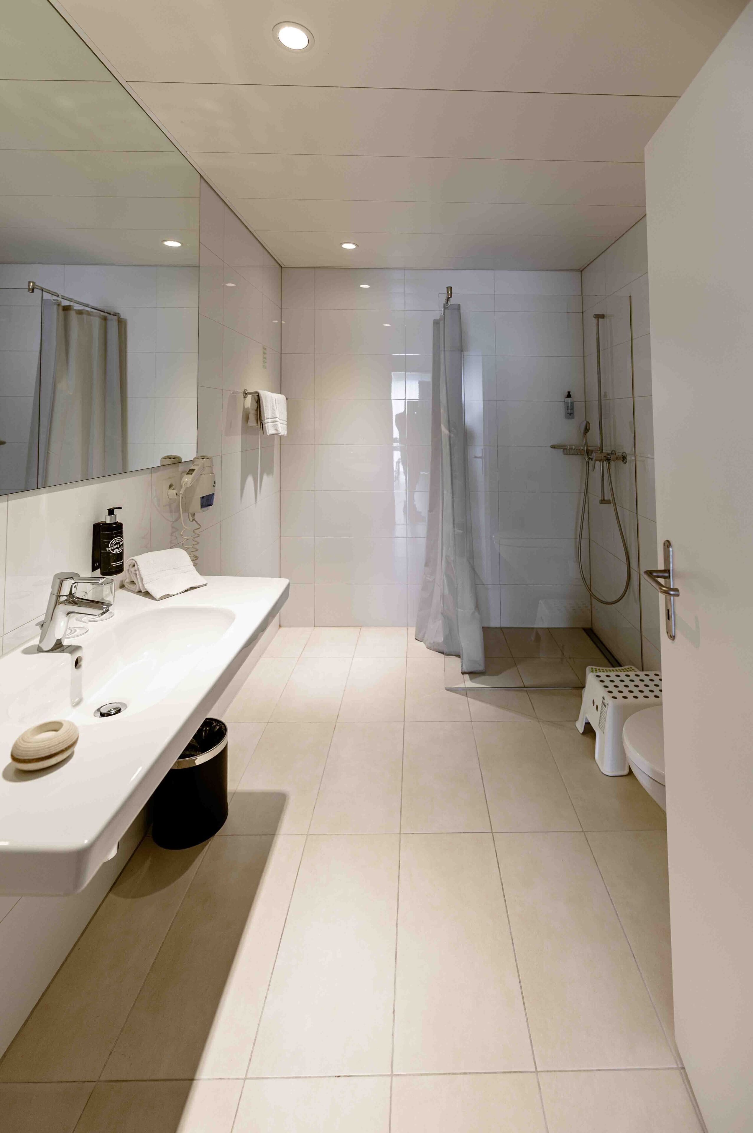 family room | bathroom | shower, hair dryer, heated floors, towels