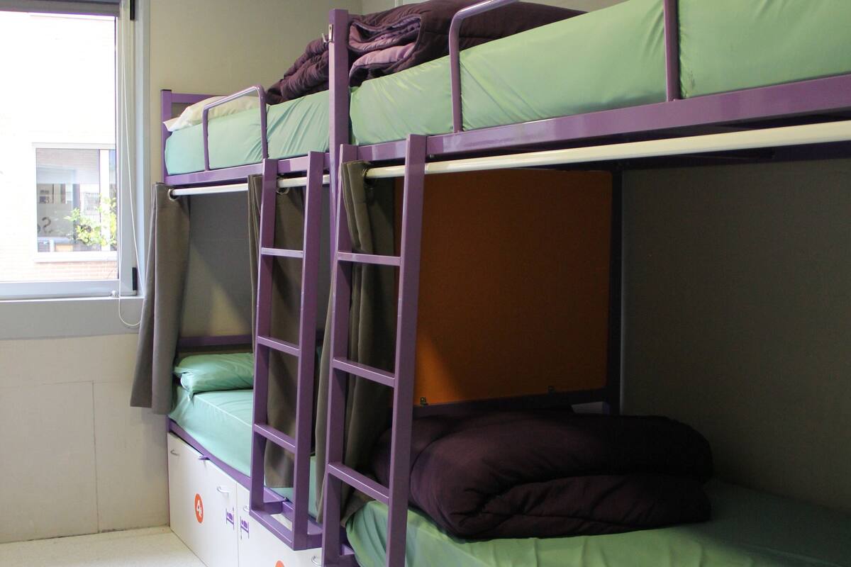 High bed in shared 6-bed female dormitory with shared bathroom | Hypo-allergenic bedding available, blackout drapes, soundproofing