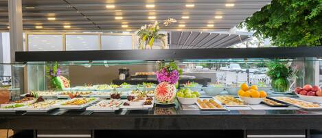 A buffet with various food items and a decorative centerpiece.