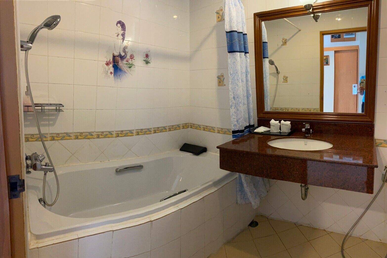 A bathroom with a bathtub, a sink, a mirror, and a shower.