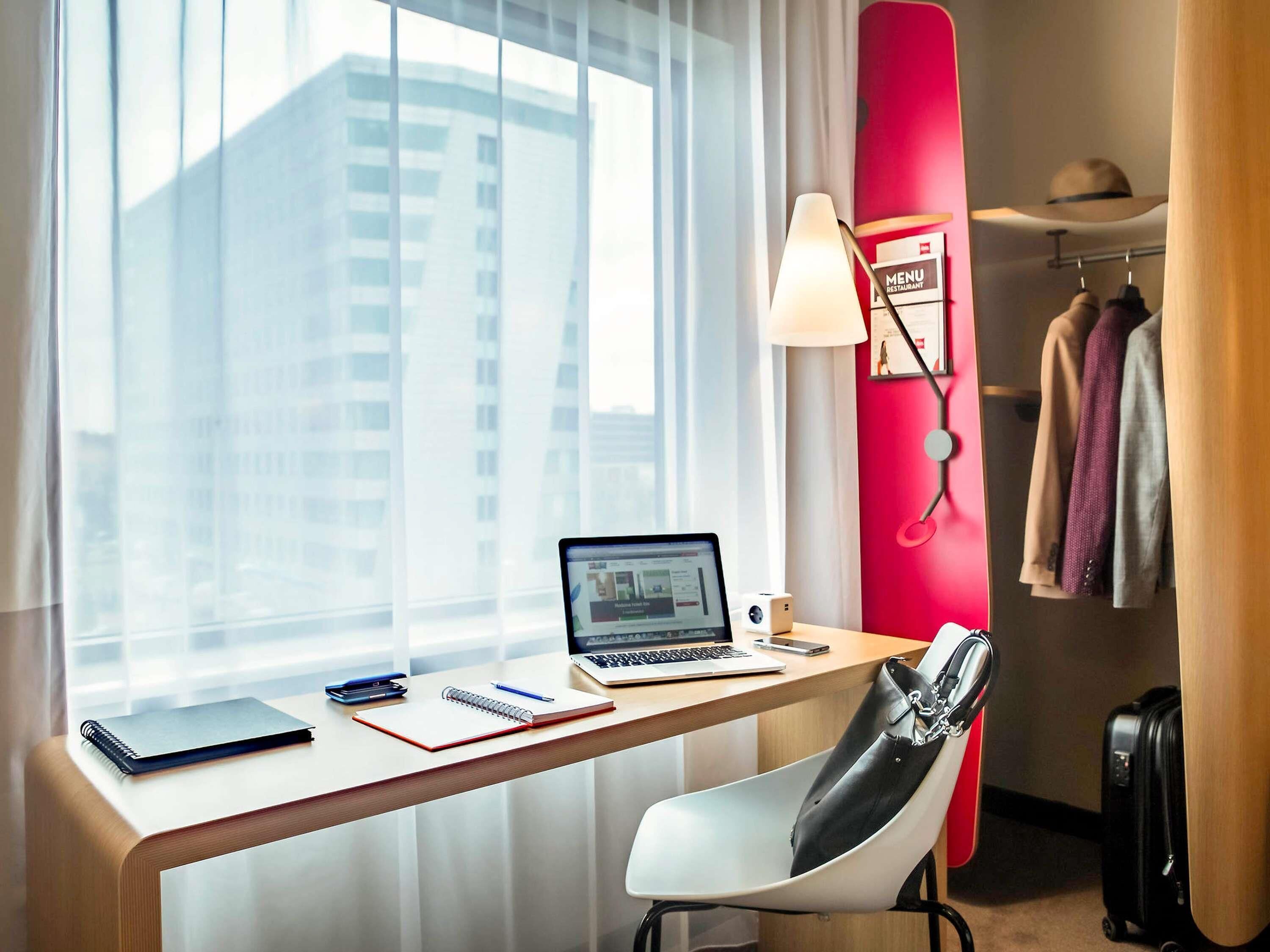 Hypo-allergenic bedding, desk, laptop workspace, blackout drapes