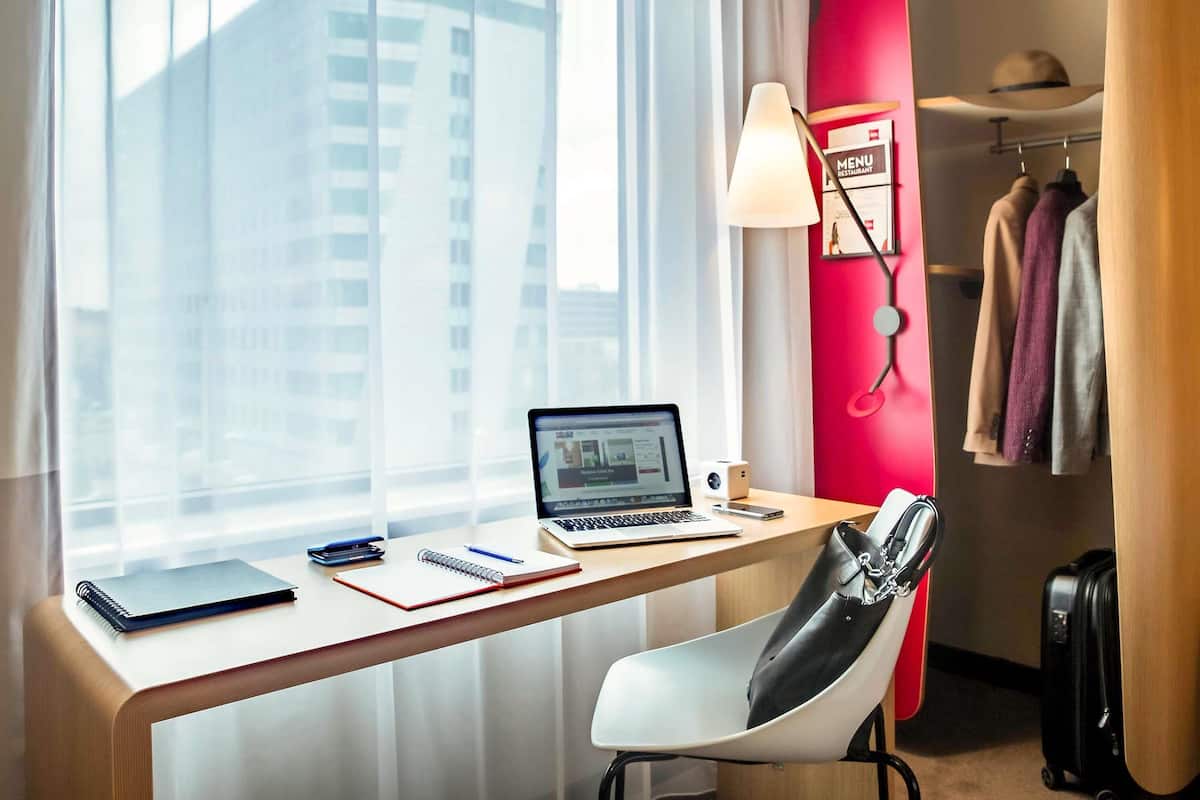 Hypo-allergenic bedding, desk, laptop workspace, blackout curtains