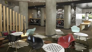 A modern interior with a reception desk, seating area, and a bar. - ibis Wroclaw Centrum (Wroclaw)
