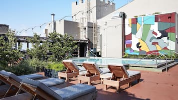 Outdoor pool, open 11:00 AM to 7:00 PM, pool loungers