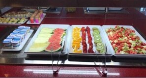 A buffet with various food items including sliced fruits and yogurt. - Hotel Atlántico Sanxenxo (Sanxenxo)