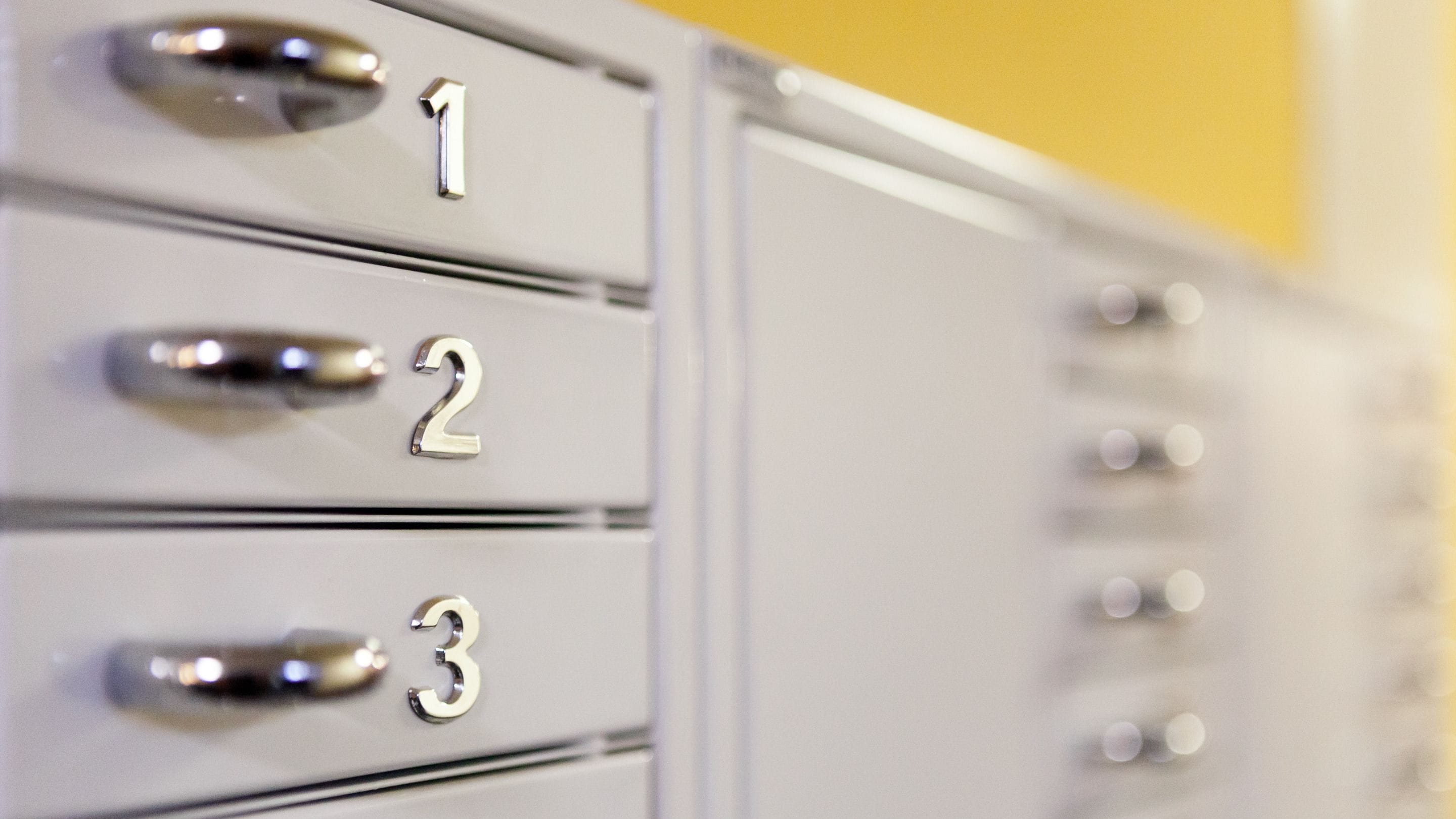 A close-up of a filing cabinet with drawers labeled 1, 2, and 3.