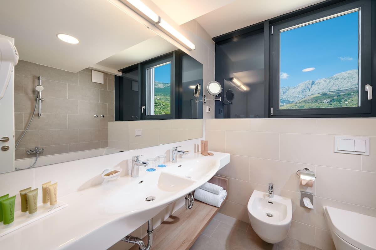 deluxe penthouse suite | bathroom | free toiletries, hair dryer, bathrobes, slippers