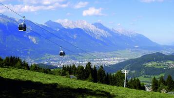 A cable car system in a mountainous area with a town in the valley below.