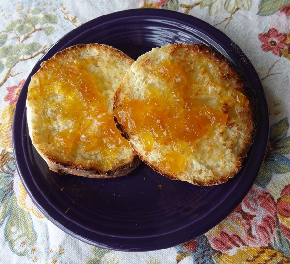 Two slices of toast with egg on a dark plate.