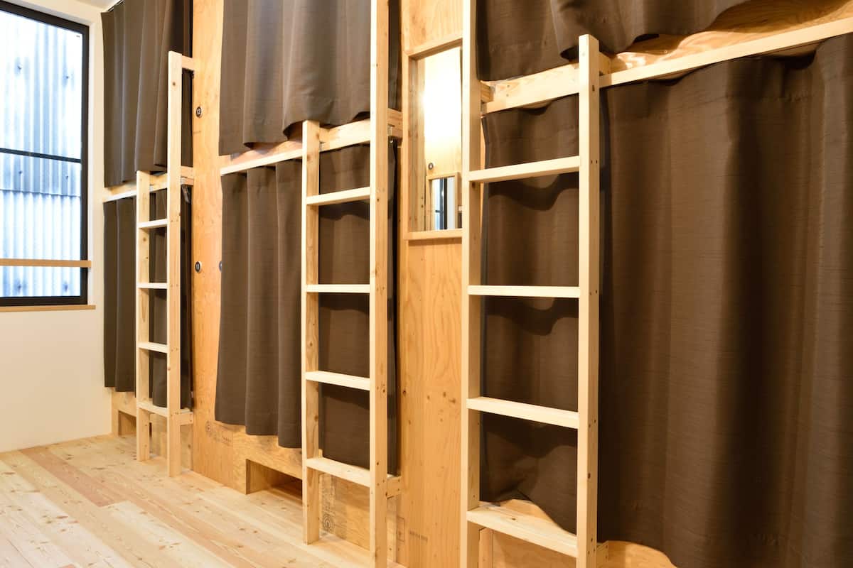 A room with bunk beds and a window with curtains.