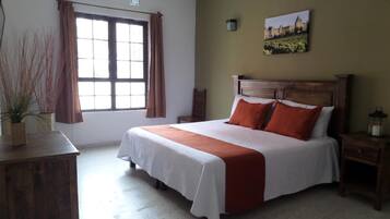 Desk, iron/ironing board, bed sheets