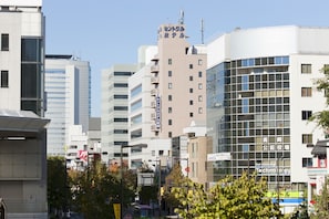 A modern urban building with multiple floors, large windows, and a prominent sign on the top. - Central Hotel Takasaki (Takasaki)