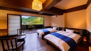 A hotel room with two beds, a wooden floor, a balcony with a view of greenery, and a traditional Japanese sliding door. - Ooedo Onsen Monogatari Terunoyu (Maniwa)