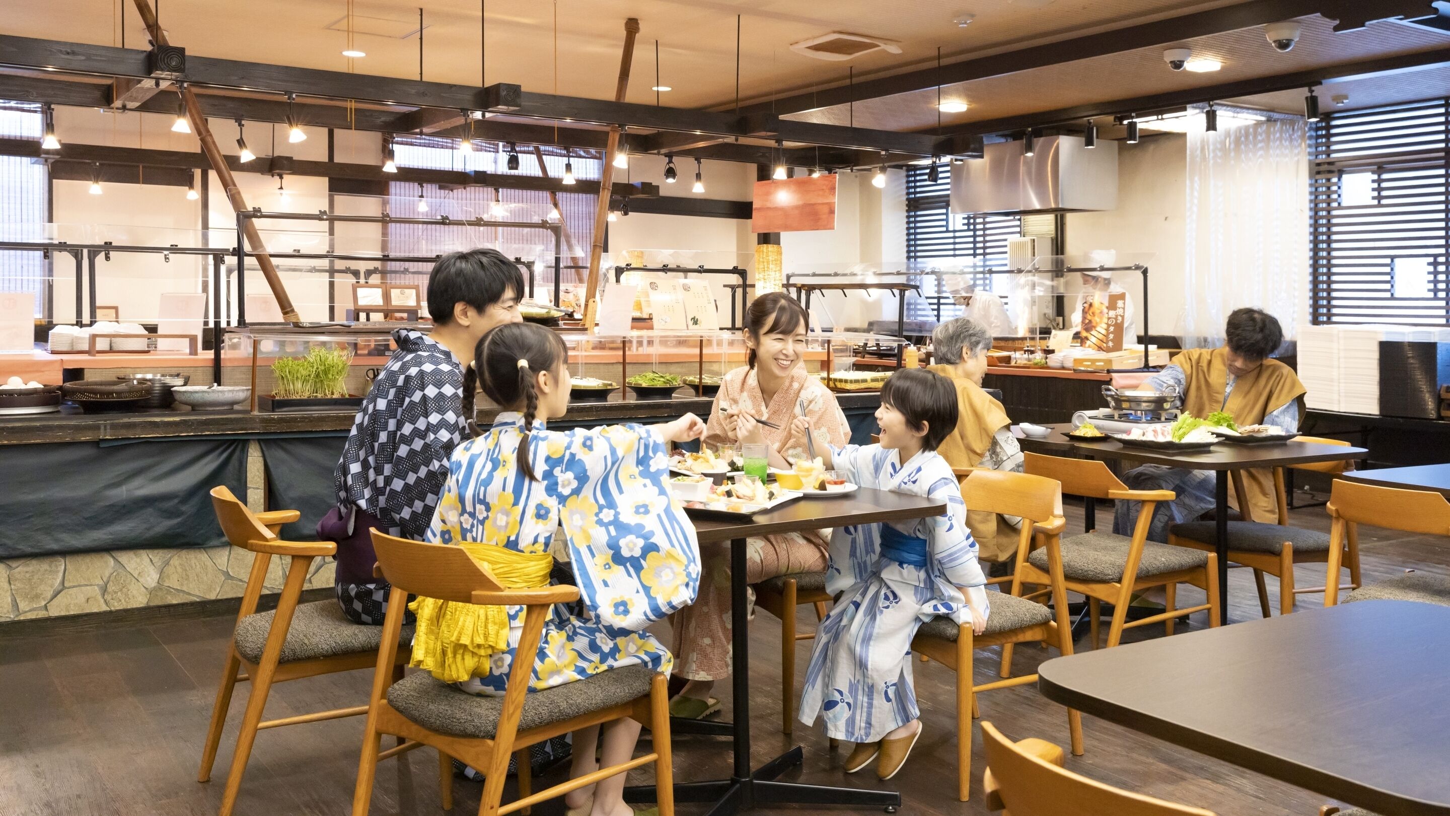 A restaurant with wooden furniture and a counter displaying food items.