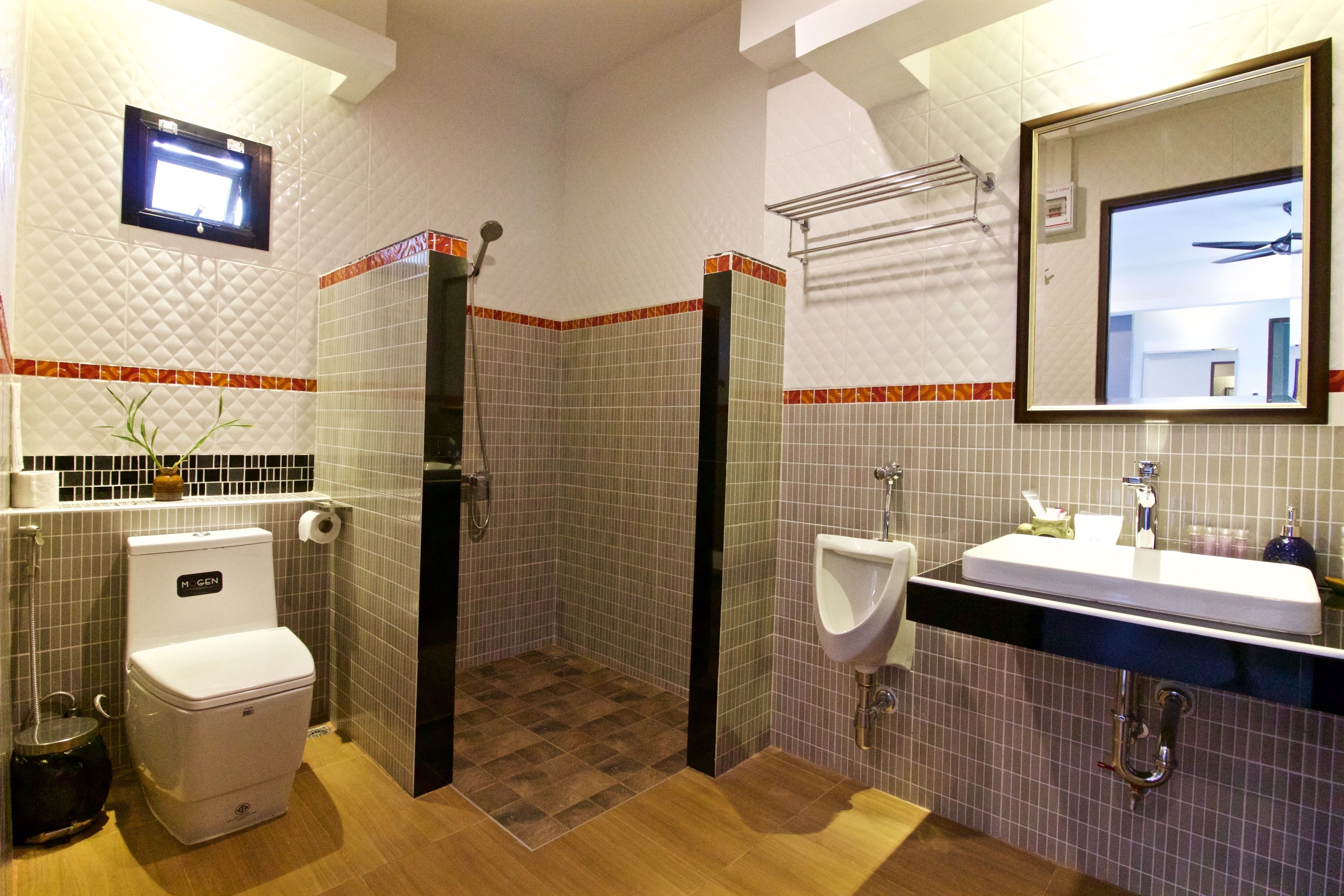 A bathroom with a toilet, bidet, and sink.