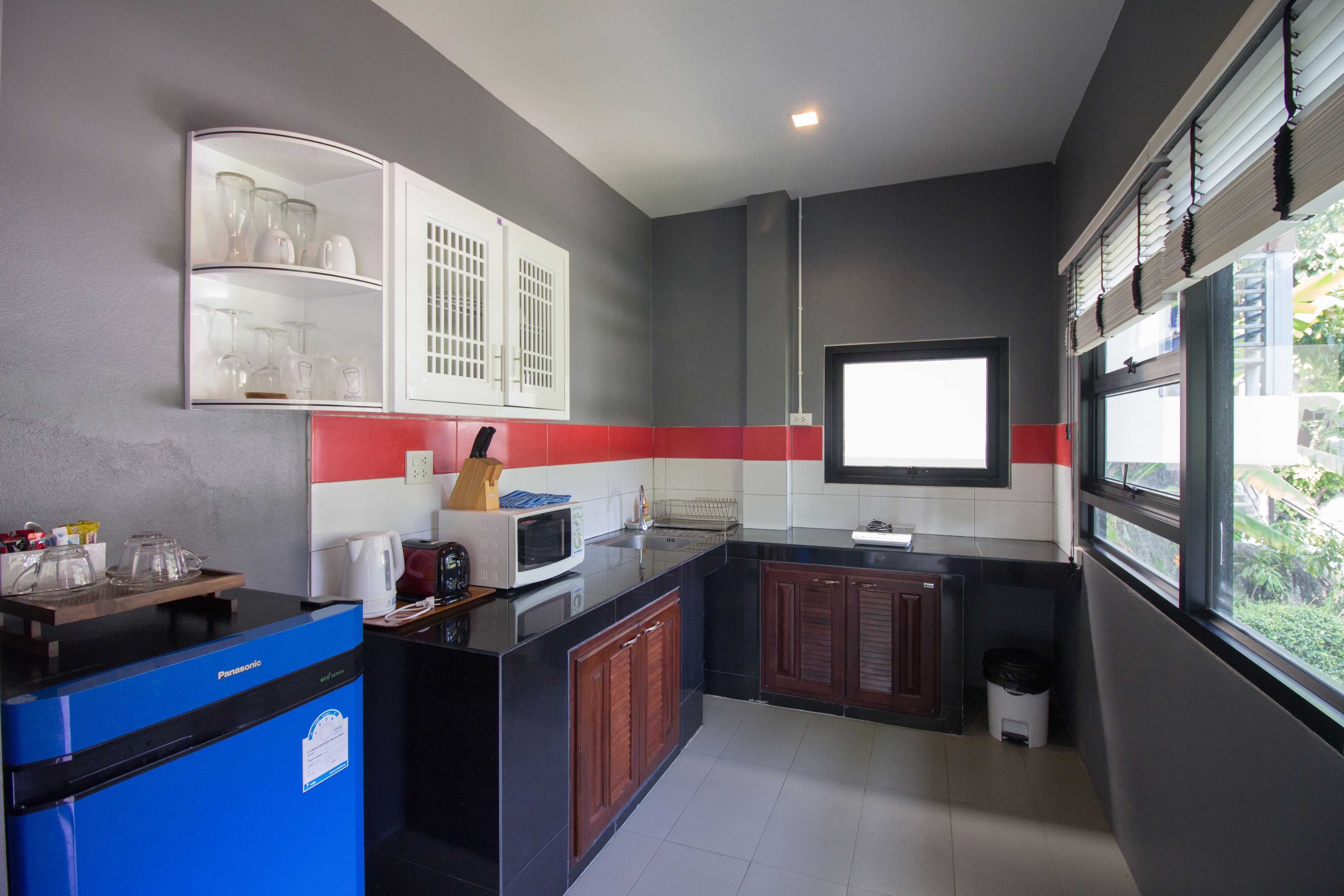 luxury room, kitchenette, sea view | in-room safe, individually decorated, desk, blackout curtains