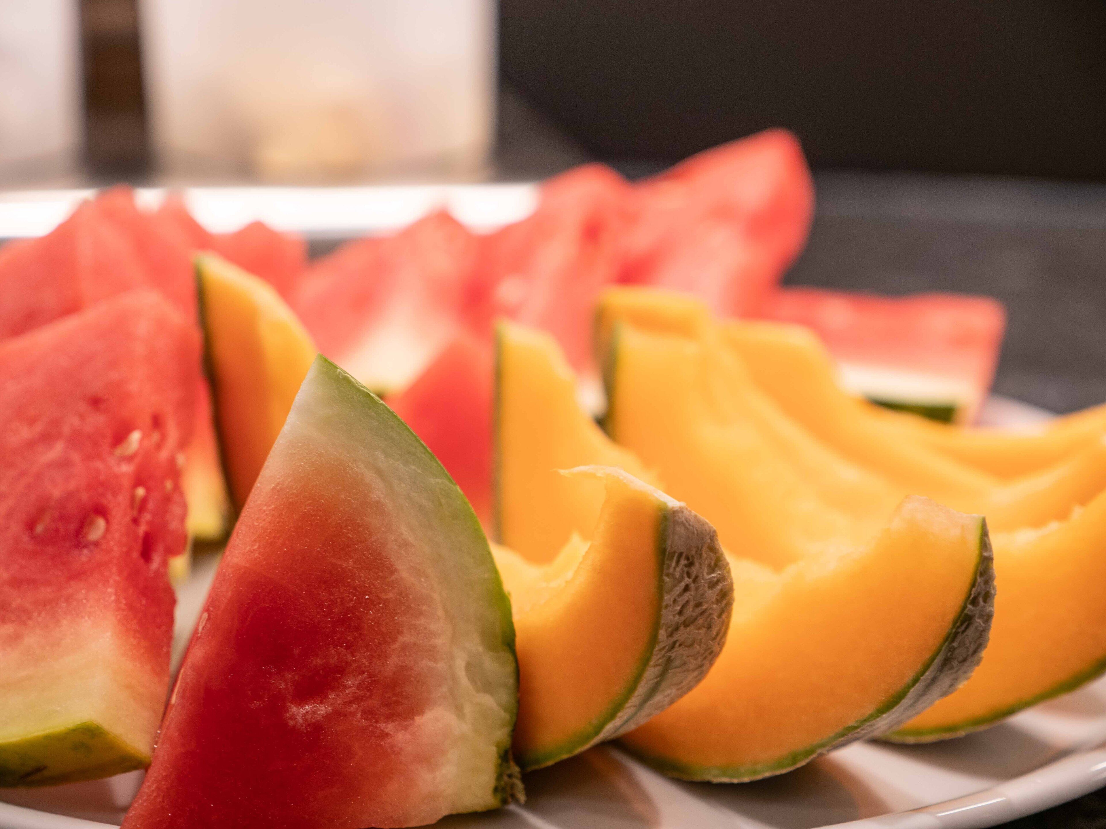 A plate with sliced watermelon and cantaloupe.