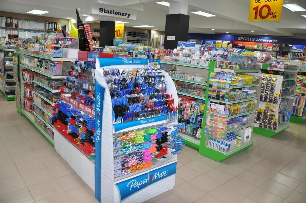 A stationery section in a store with a 10% discount sign.