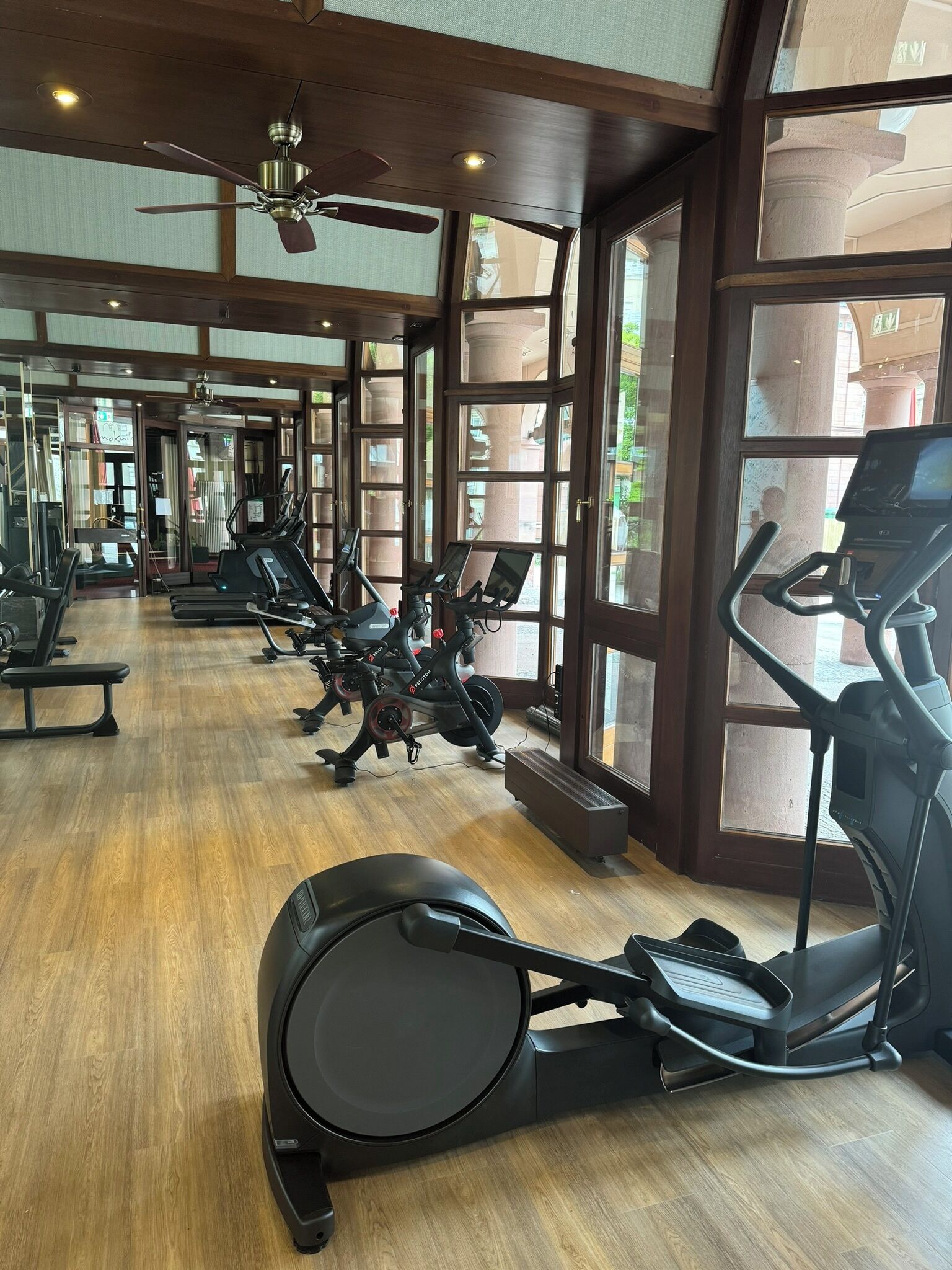 A gym with multiple treadmills, exercise bikes, and benches.