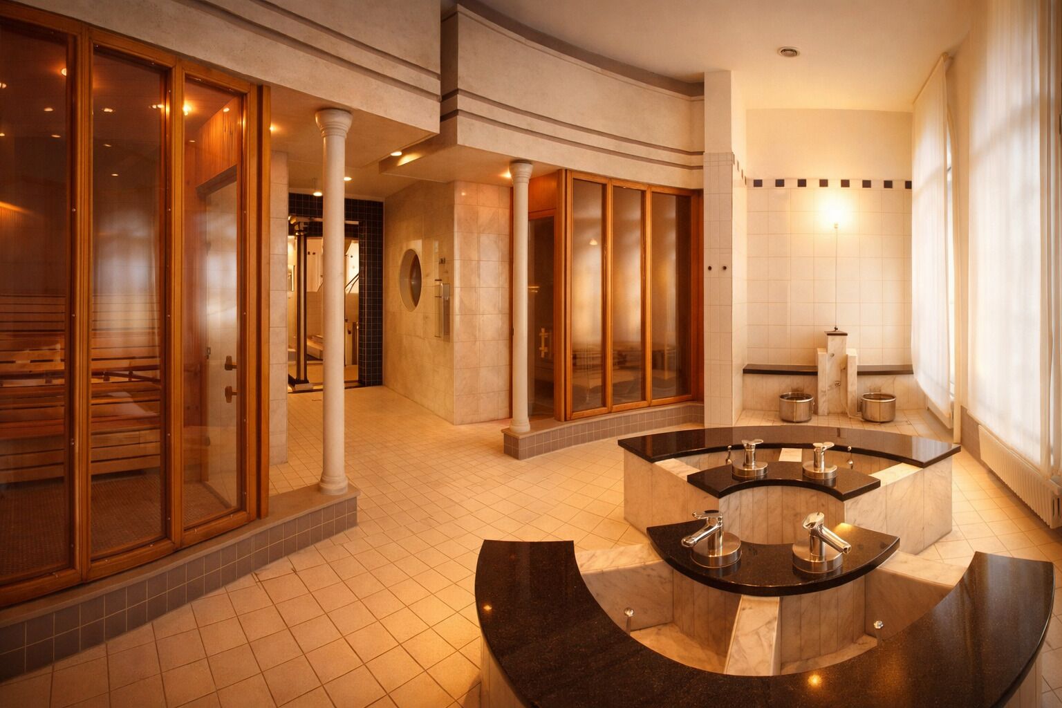A modern bathroom with a freestanding bathtub, a vanity with a mirror, and a large window providing natural light.