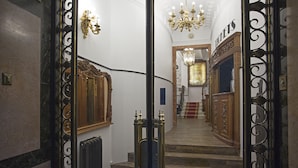 A grand staircase with ornate railings and a chandelier, leading to a room labeled "HOTELS". - Casual del Teatro Madrid Hotel by Casual Hoteles (Madrid)