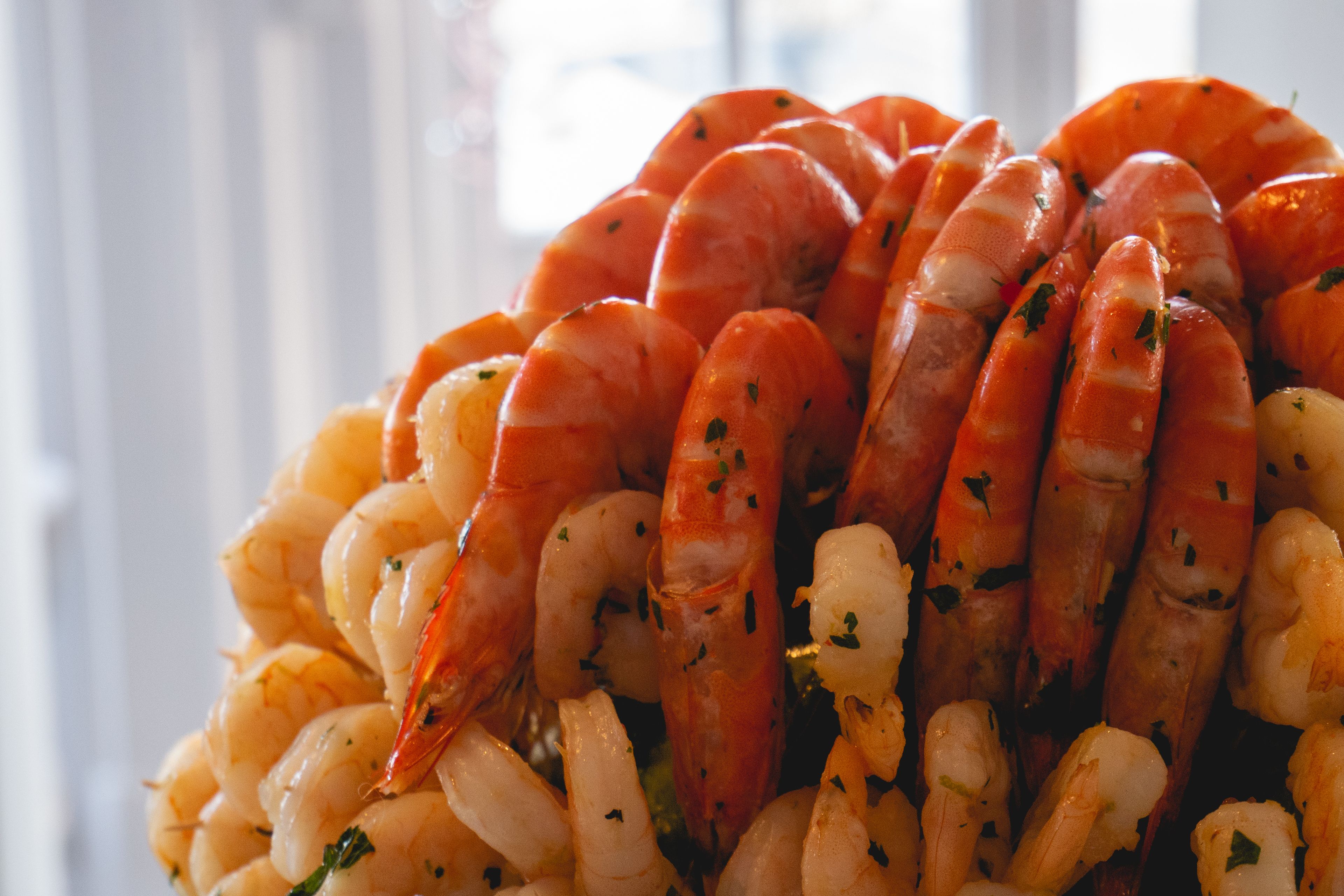 A close-up of cooked shrimp arranged in a pile.