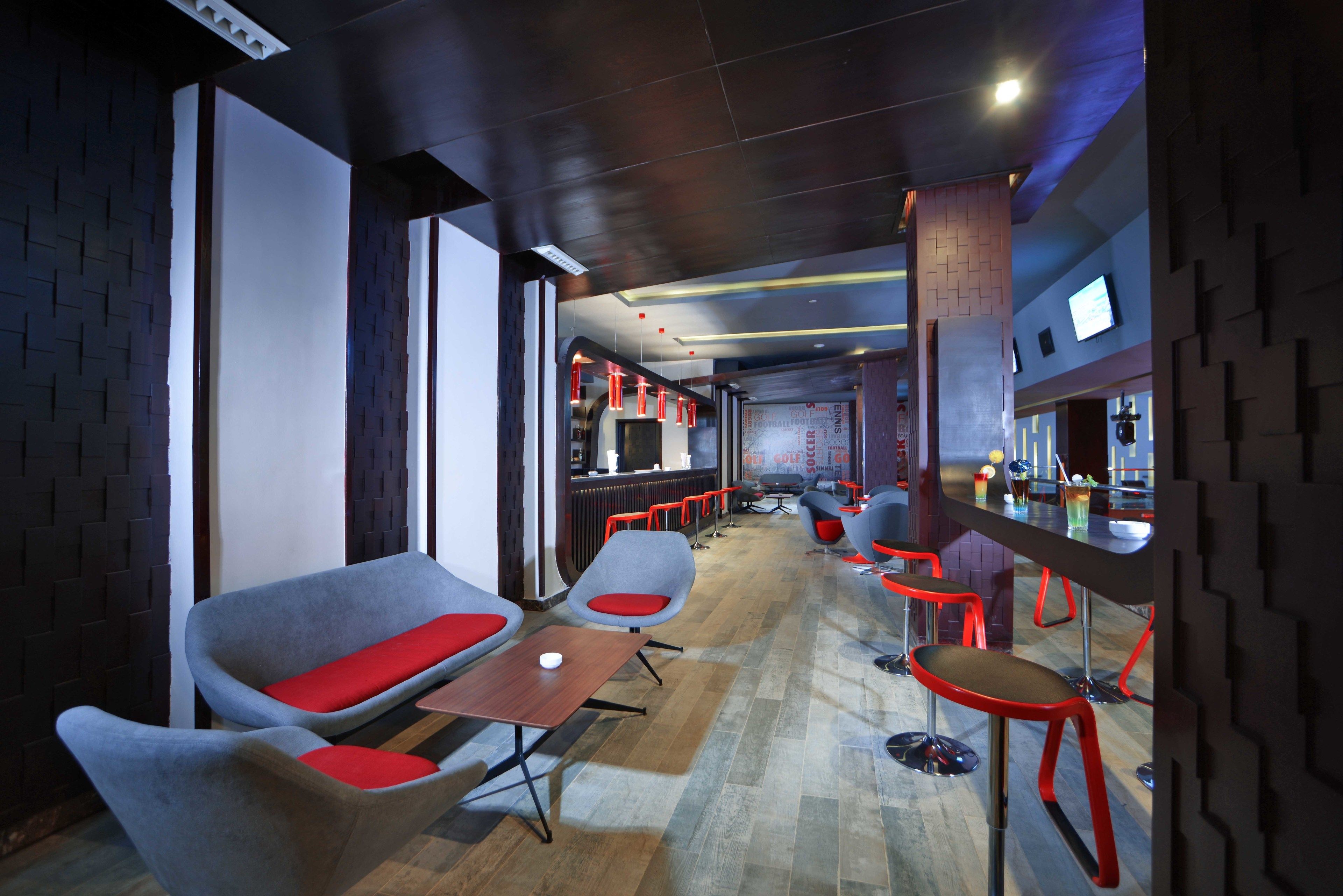 A modern bar area with seating and a counter.
