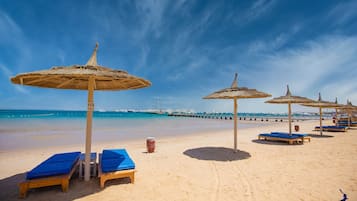 Praia particular, espreguiçadeiras, guarda-sóis, toalhas de praia