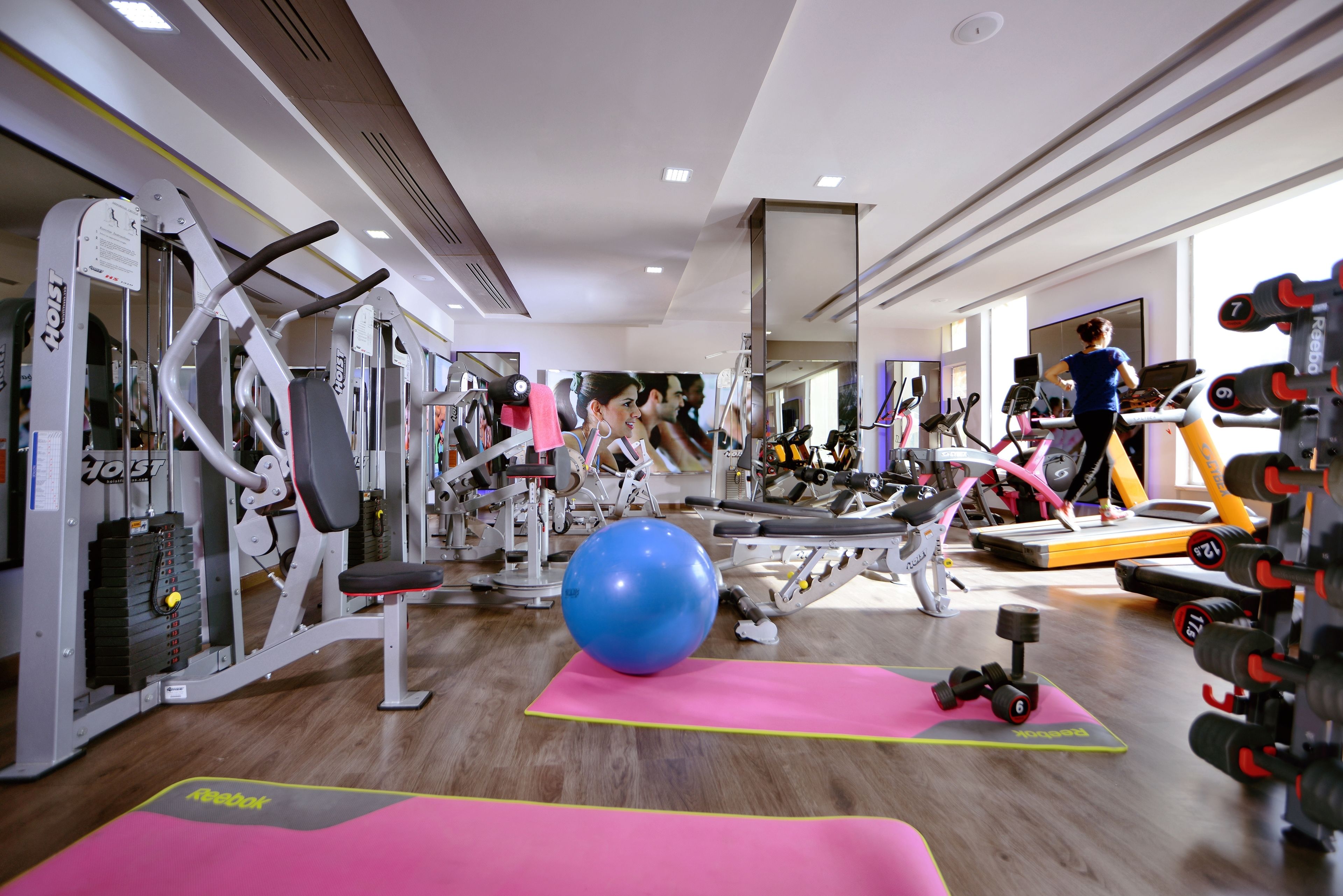 A gym with cardio equipment, weight machines, and free weights.