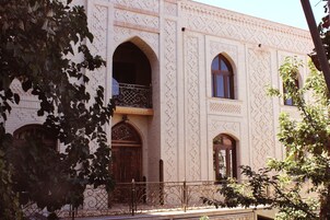 A building with arched windows and a patterned facade.