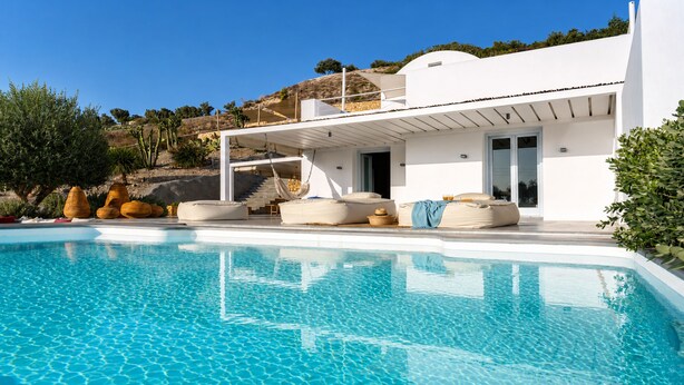 A modern house with a swimming pool, outdoor seating, and a staircase leading to a terrace. - Santorini Heights (Santorini)