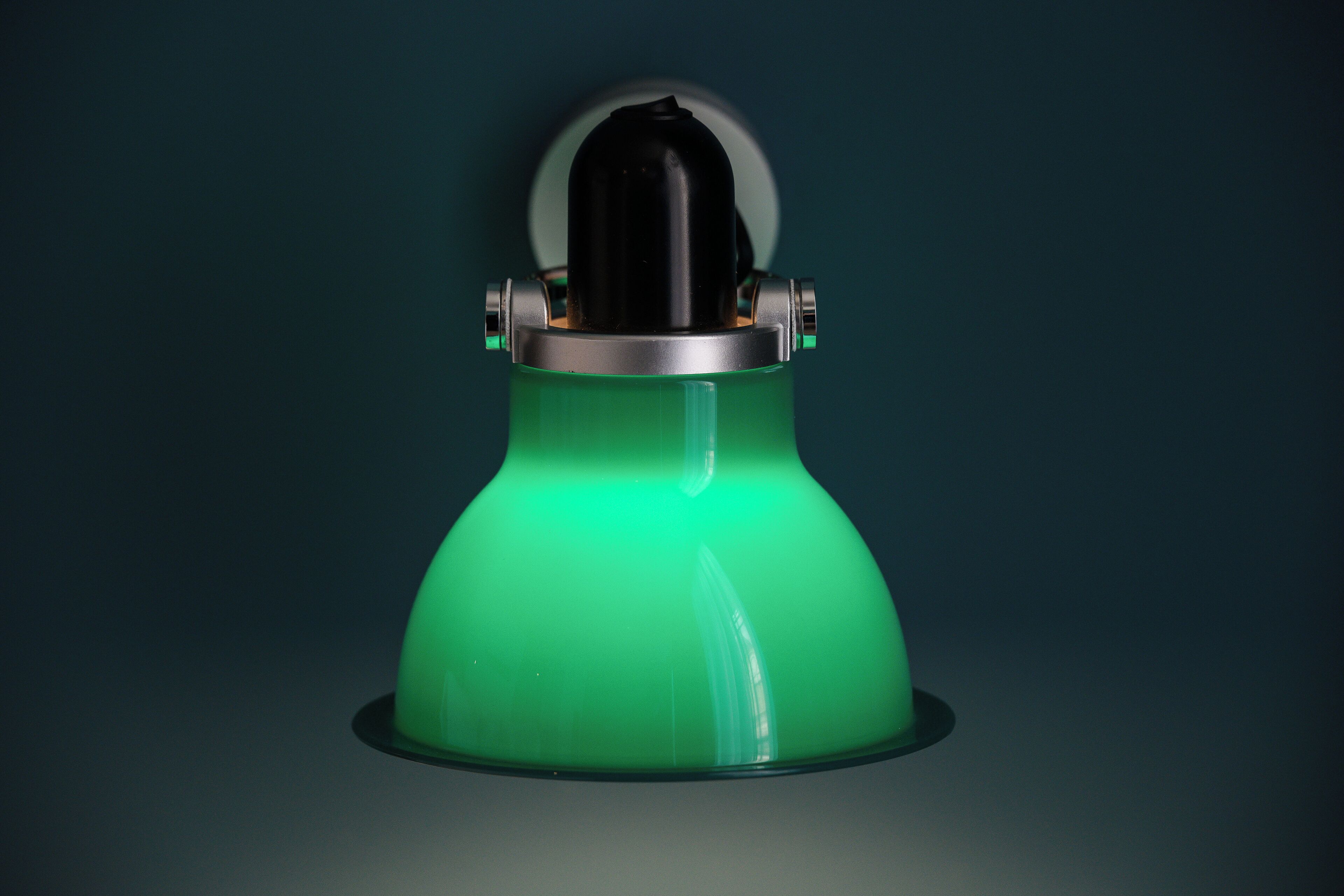 A green object with a spherical top and metallic components.
