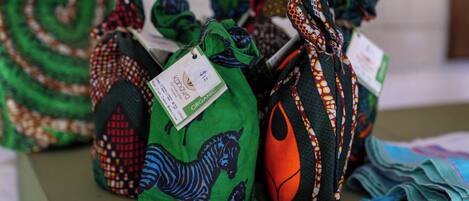 A table with several bags of organic fabric, each with a tag.