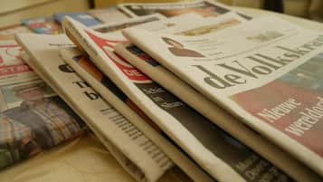 A stack of newspapers on a table.