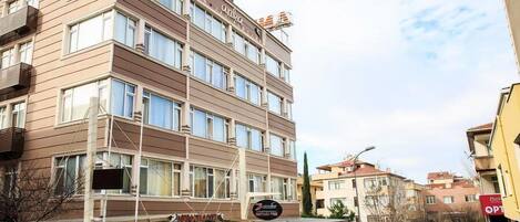 A multi-story hotel with a sign reading "ANKA HOTEL" and a visible restaurant named "Zarife Restaurant".