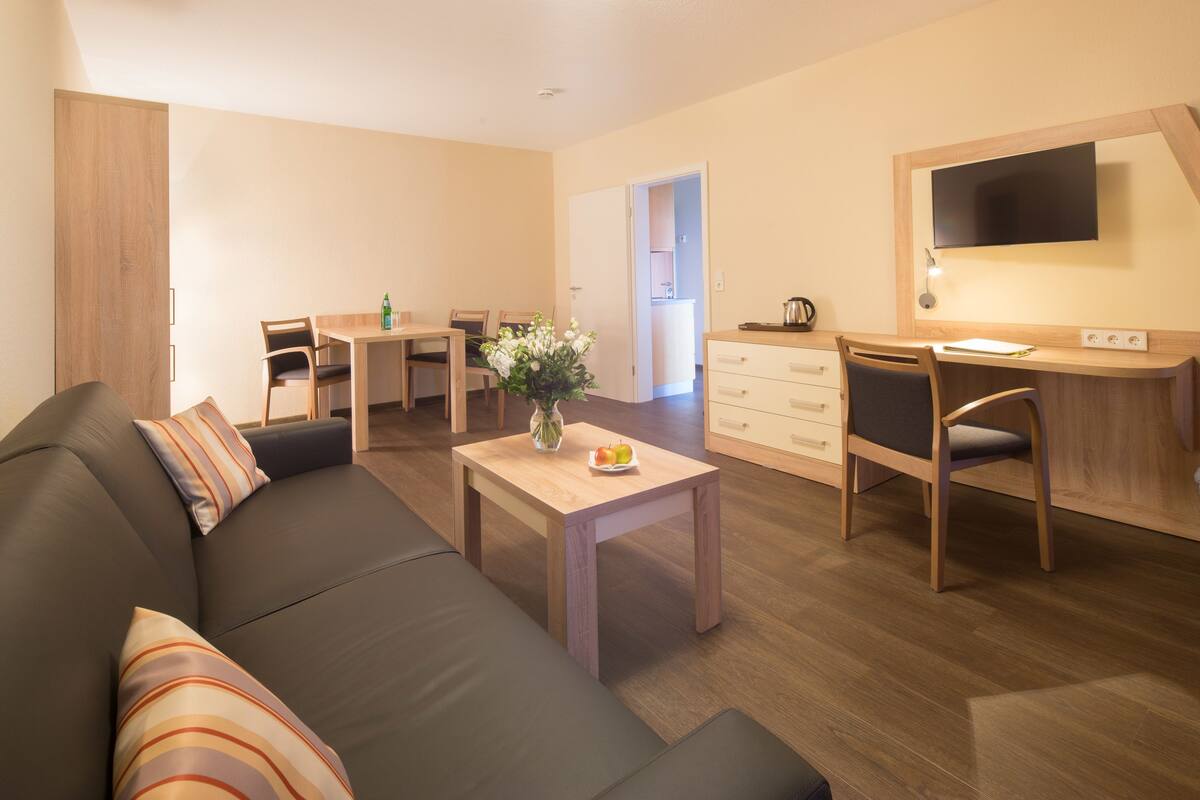 Comfort Suite, 1 Bedroom | Living room | 18-inch LCD TV with cable channels, TV