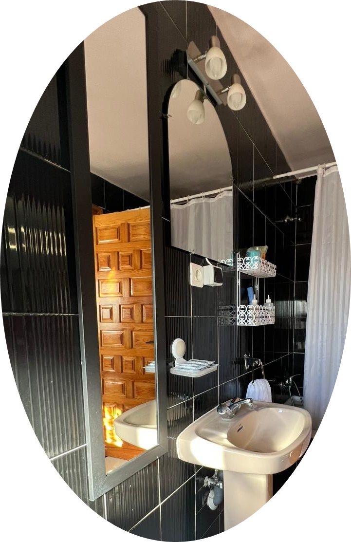 A bathroom with a modern design, featuring a wooden wall, a sink, and a mirror.