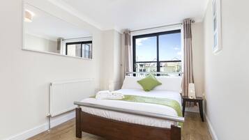 1 habitación, escritorio y tabla de planchar con plancha