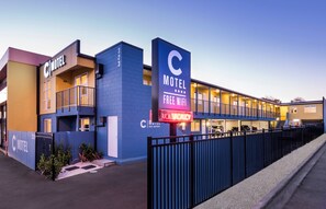 A motel with a prominent 'C' sign, a 'Free WiFi' sign, and a 'No Parking' sign. - C Motel (Christchurch)
