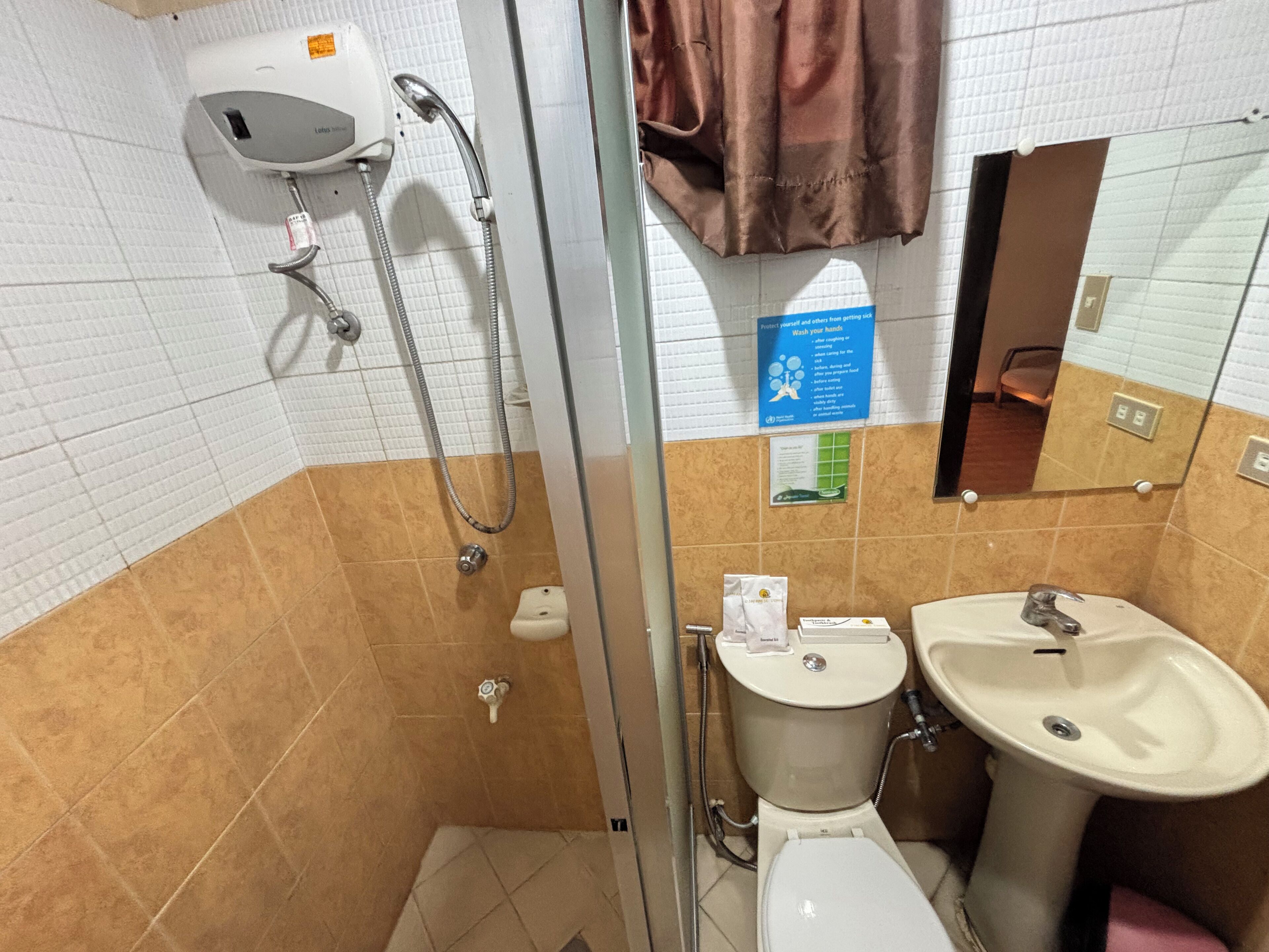 A bathroom with a shower, toilet, and sink.
