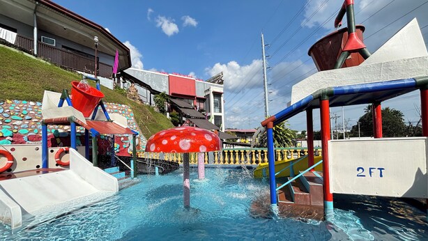 A water play area with slides and a large mushroom-shaped water feature. - D'Japanese Tunnel Family Resort (Davao)