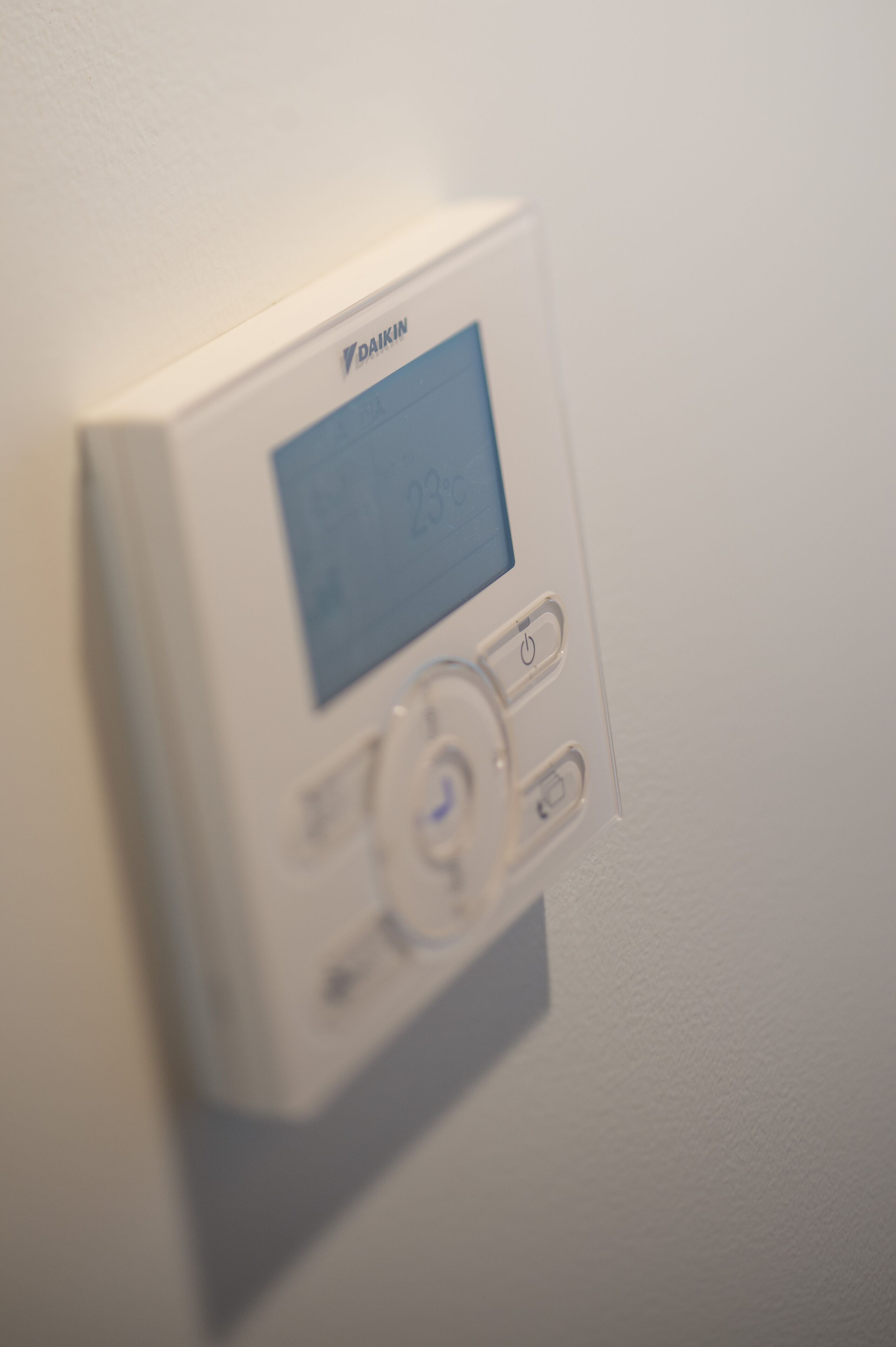 A thermostat mounted on a wall.