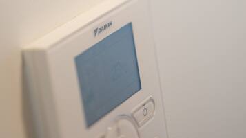 A thermostat mounted on a wall.