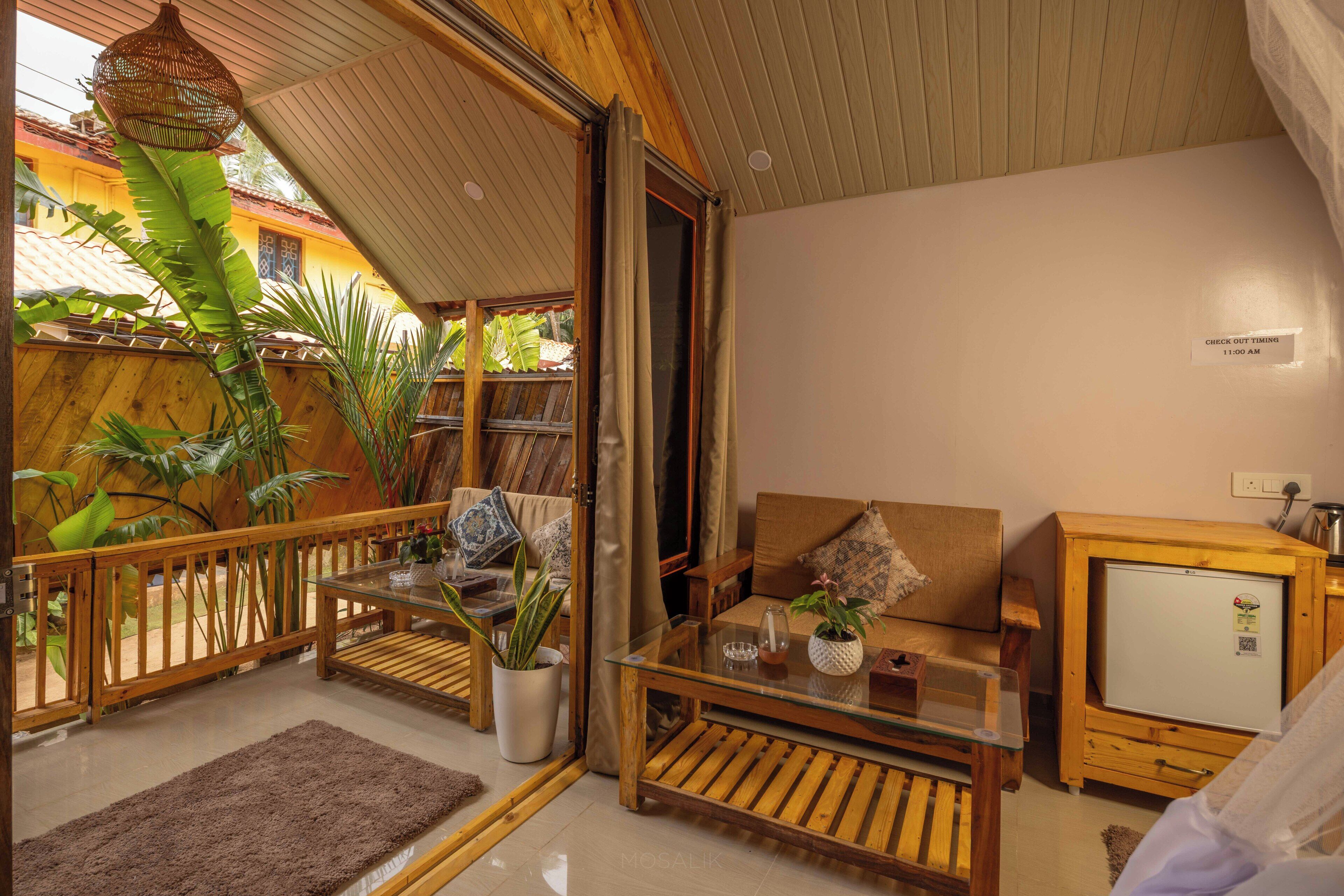 A cozy living area with a wooden table, sofa, and a small TV.