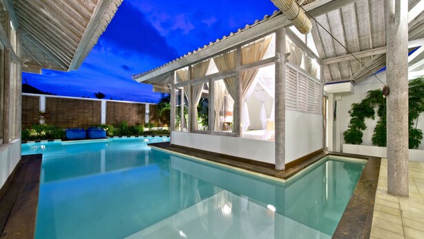 A swimming pool with a covered area, clear blue water, and a view of the sky. - Villa Laksmana Hideaway 2 (Seminyak)