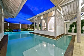 A swimming pool with a covered area, clear blue water, and a view of the sky. - Villa Laksmana Hideaway 2 (Seminyak)