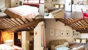 A suite with a bedroom, living area, and kitchen. The suite has wooden beams on the ceiling, a large bed, a sofa, a dining table, and a kitchen with a refrigerator and stove. - Palazzo Meraviglia - Albergo Diffuso (Corinaldo)