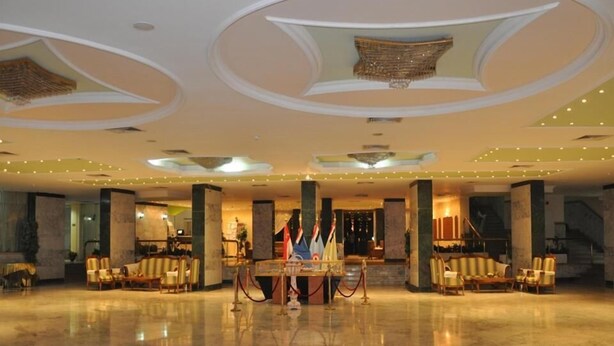 A spacious lobby with a marble floor, a reception desk, and seating areas. - Minya Hotels of the Armed Forces (El Minya)