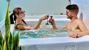 A couple in a hot tub with a plant beside them. - Margaret of Naxos (Naxos)